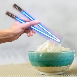 The human beings holding chopsticks are glowing with lights. And he is eating nodals with chopsticks.