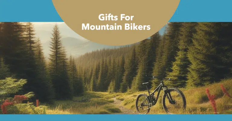 There is a bike in the middle of the mountain, there are beautiful trees on all sides. Above it is written "Gifts For Mountain Bikers".